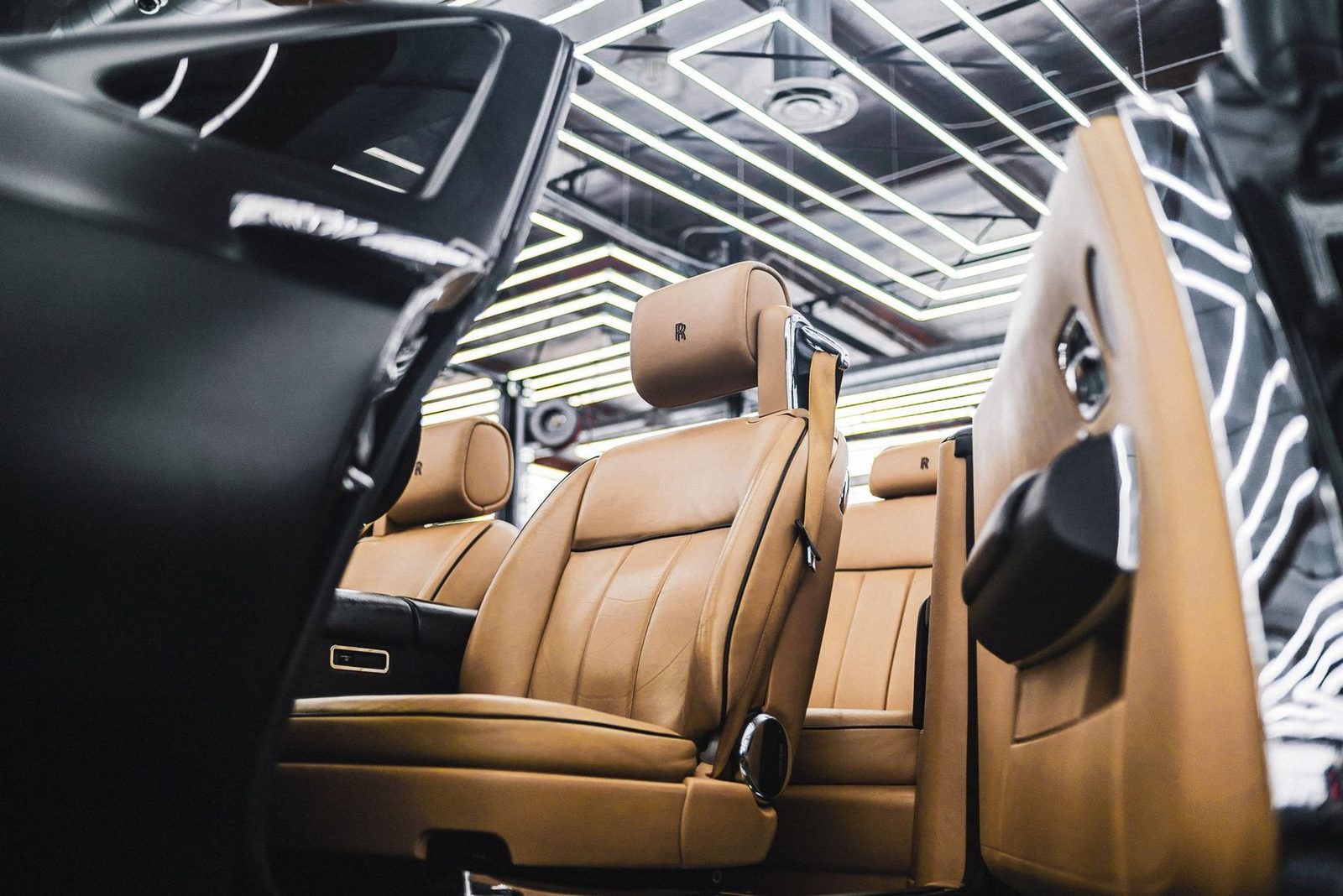 The interior of a luxury car with tan leather seats